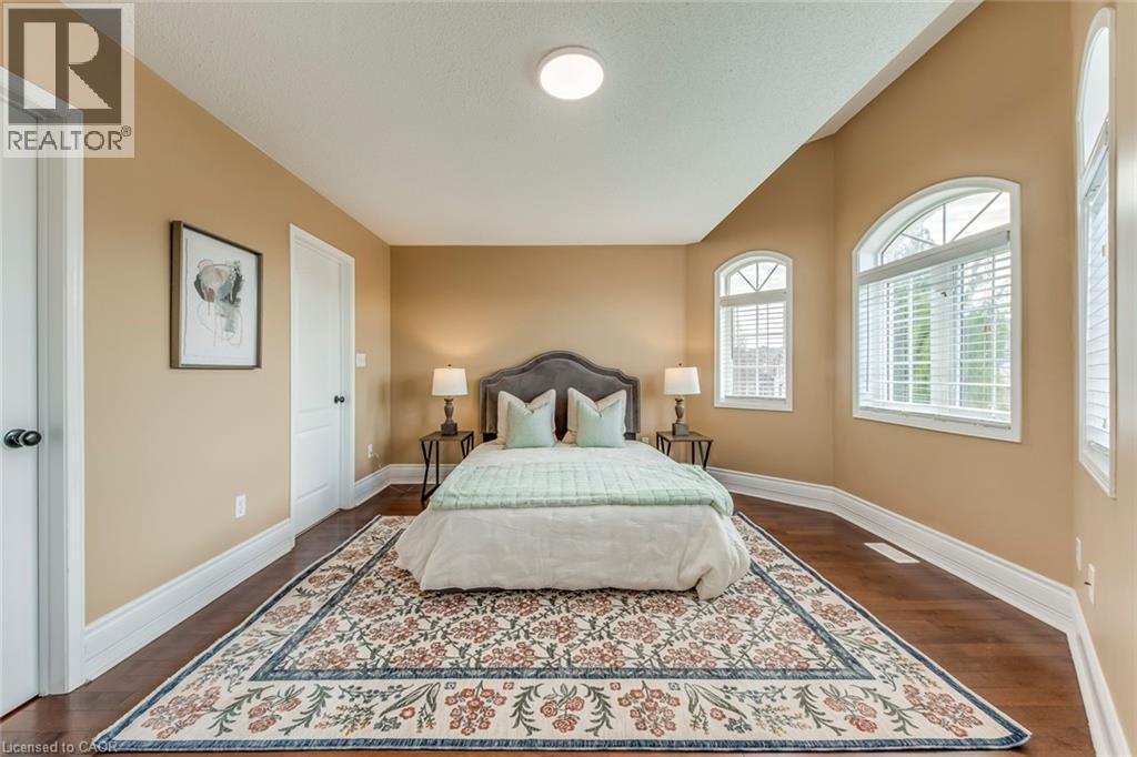 Bedroom featuring baseboards and dark wood finished floors - 5811 Page Crescent, Burlington, ON - Indoor Photo Showing Bedroom