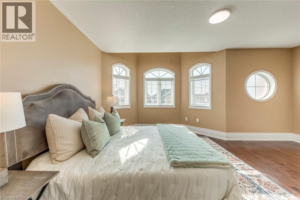Bedroom featuring dark wood-style floors and a textured ceiling - 5811 Page Crescent, Burlington, ON - Indoor Photo Showing Bedroom