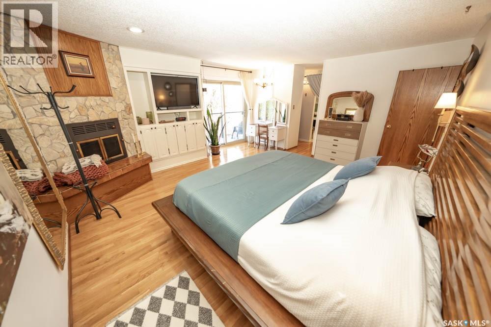 715 Emerald Bay, Saskatoon, SK - Indoor Photo Showing Bedroom With Fireplace