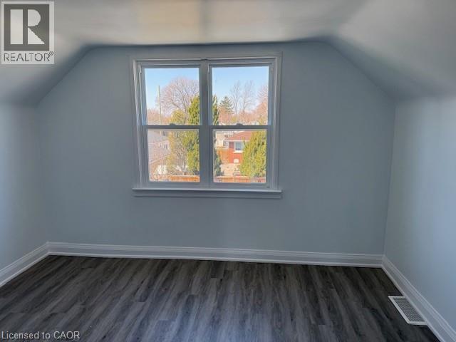 Bonus room with lofted ceiling and dark wood-style flooring - 322 Upper Gage Avenue, Hamilton, ON - Indoor Photo Showing Other Room