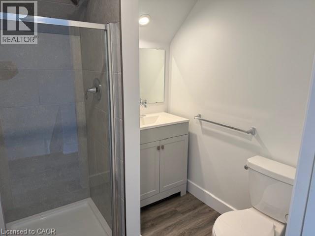 Bathroom featuring vanity, dark wood finished floors, a stall shower, and recessed lighting - 322 Upper Gage Avenue, Hamilton, ON - Indoor Photo Showing Bathroom