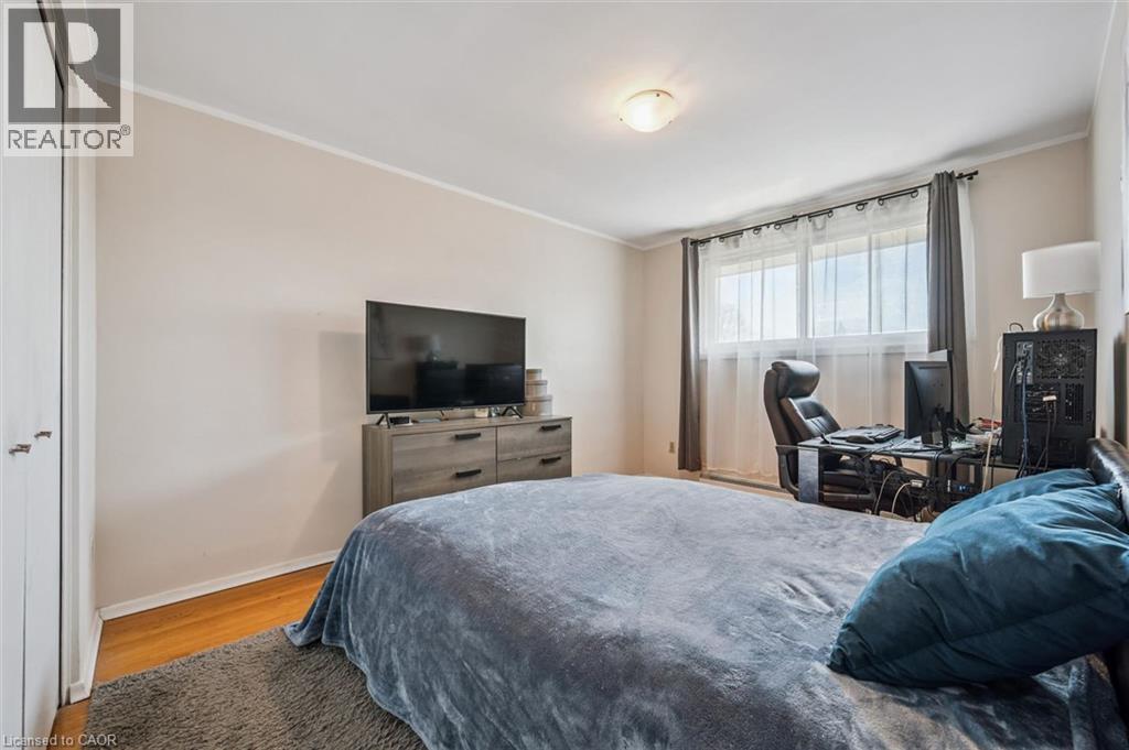 Bedroom featuring ornamental molding and light wood-type flooring - 55 Ralgreen Crescent, Kitchener, ON - Indoor Photo Showing Bedroom