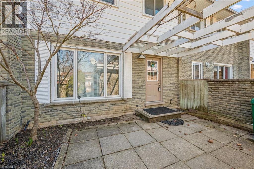 View of exterior entry featuring a patio area and brick siding - 55 Ralgreen Crescent, Kitchener, ON - Outdoor