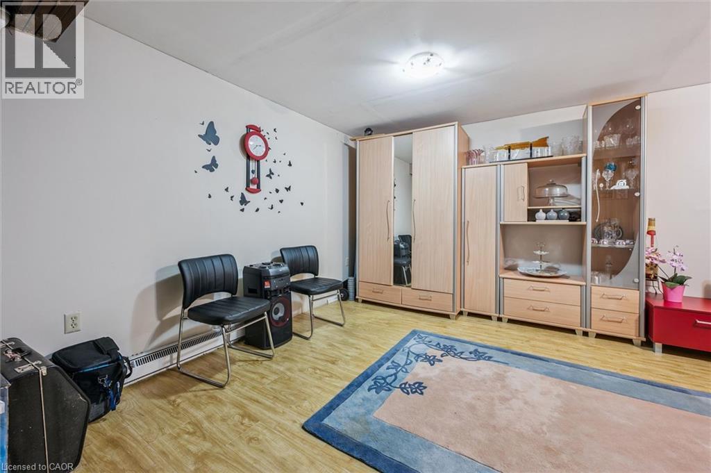 Sitting room with light wood-style floors and a baseboard heating unit - 55 Ralgreen Crescent, Kitchener, ON - Indoor