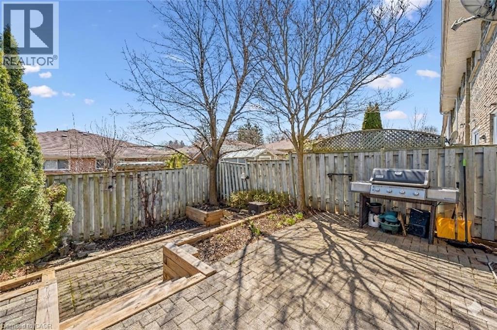 Fenced backyard featuring a garden, a patio area, and a grill - 55 Ralgreen Crescent, Kitchener, ON - Outdoor