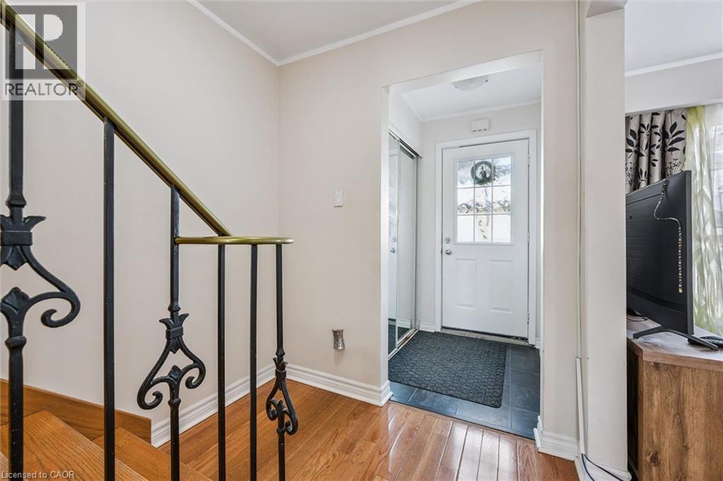 Foyer entrance with crown molding and light wood-type flooring - 55 Ralgreen Crescent, Kitchener, ON - Indoor Photo Showing Other Room