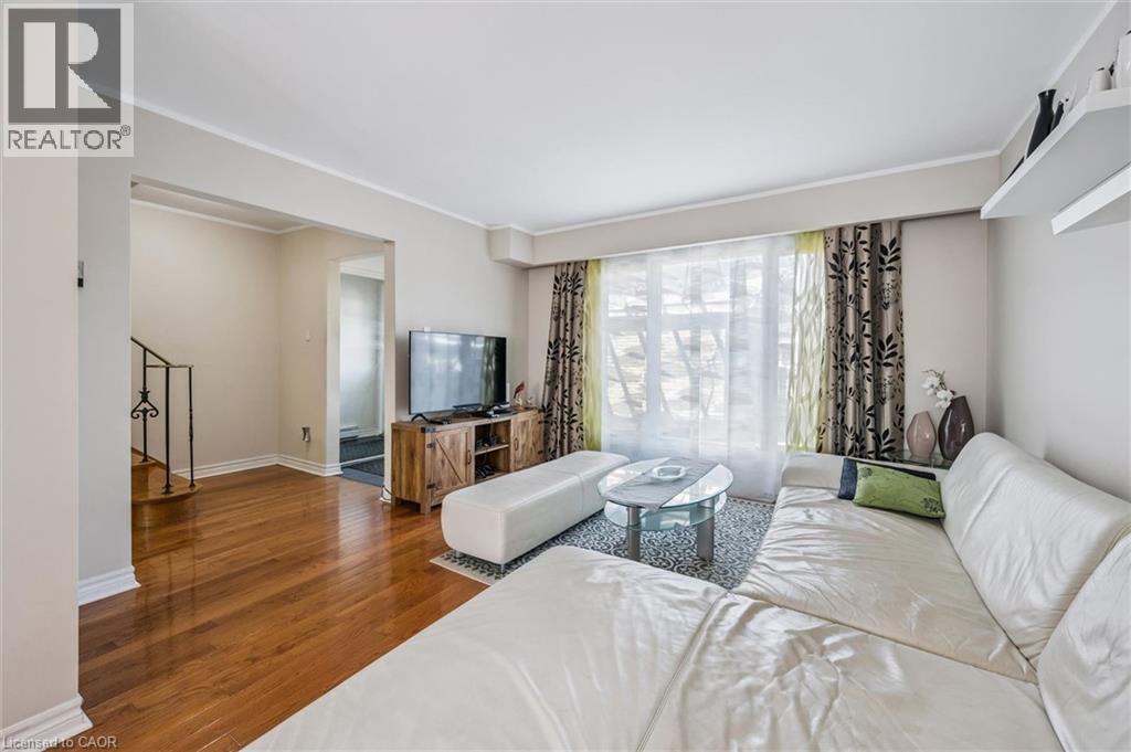 Living area featuring dark wood-style floors and crown molding - 55 Ralgreen Crescent, Kitchener, ON - Indoor Photo Showing Living Room