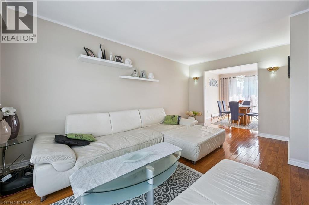 Living area with dark wood-style flooring and baseboards - 55 Ralgreen Crescent, Kitchener, ON - Indoor Photo Showing Living Room