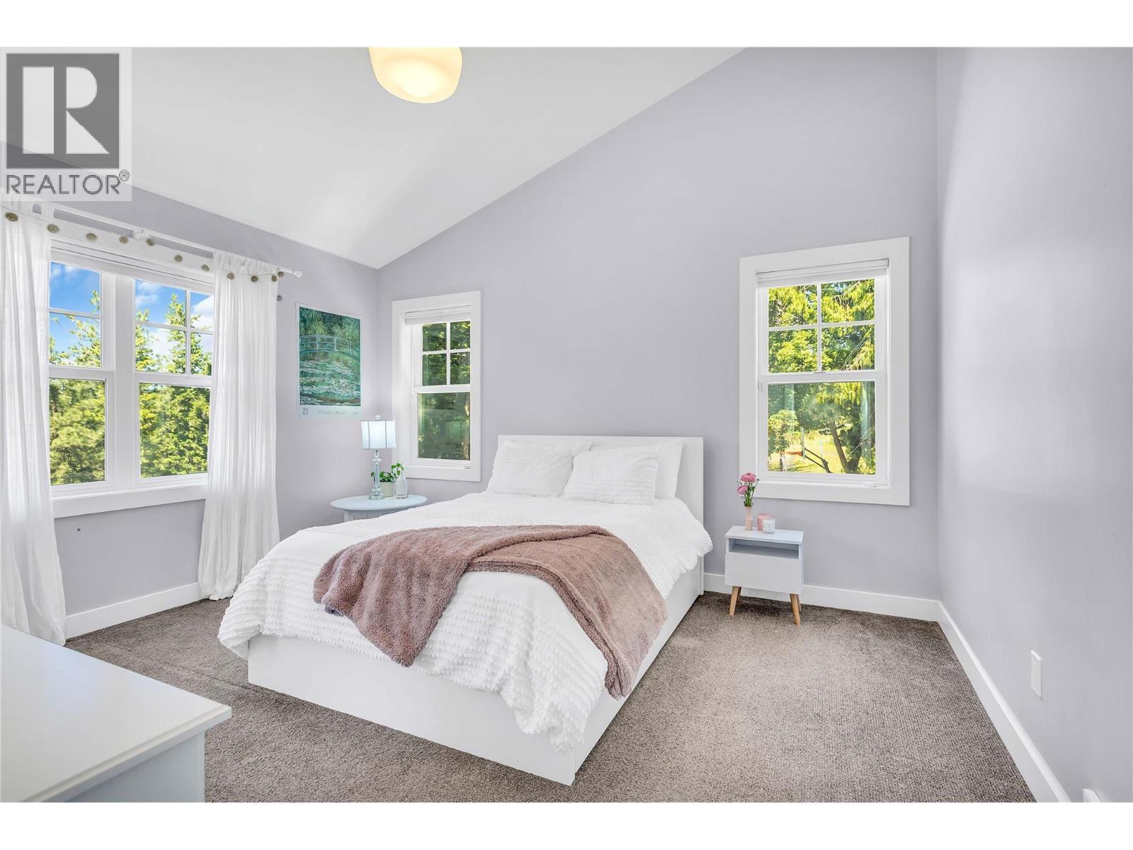 Main level bedroom with ensuite and large walk in closet - 2376 Saucier Road, Kelowna, BC - Indoor Photo Showing Bedroom