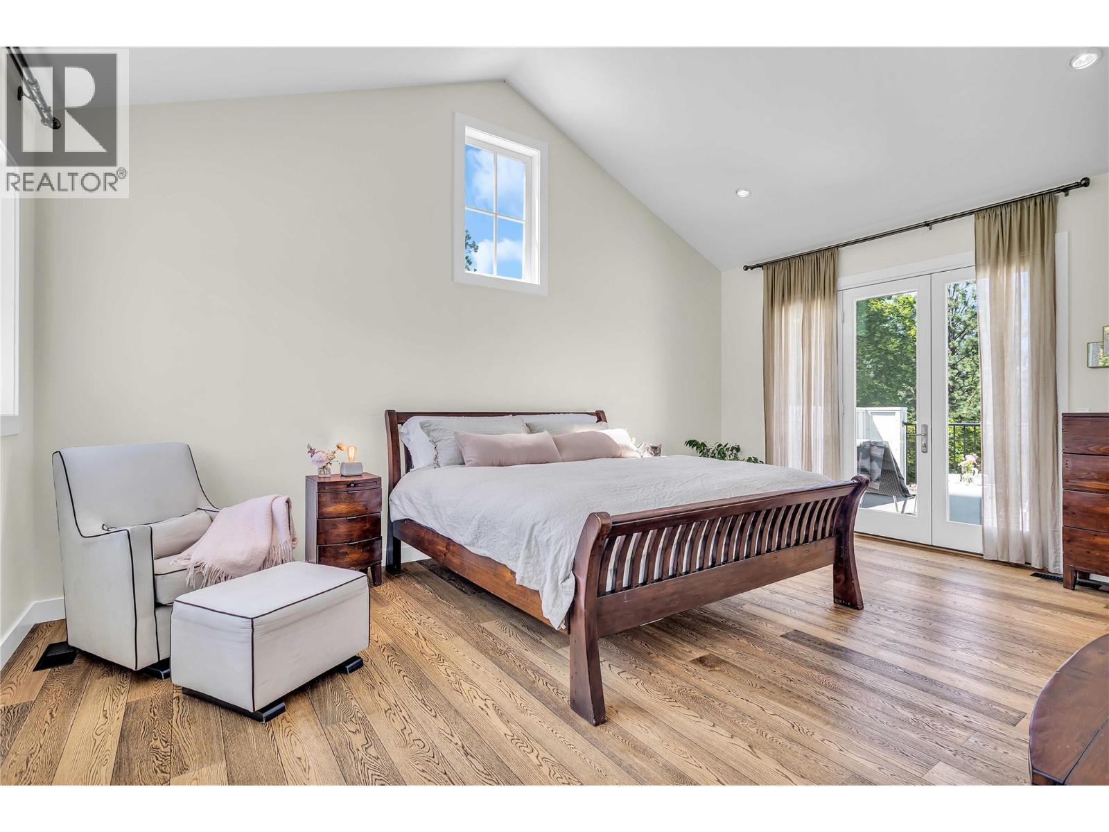 Primary bedroom on upper level with french doors to spacious and private deck - 2376 Saucier Road, Kelowna, BC - Indoor Photo Showing Bedroom
