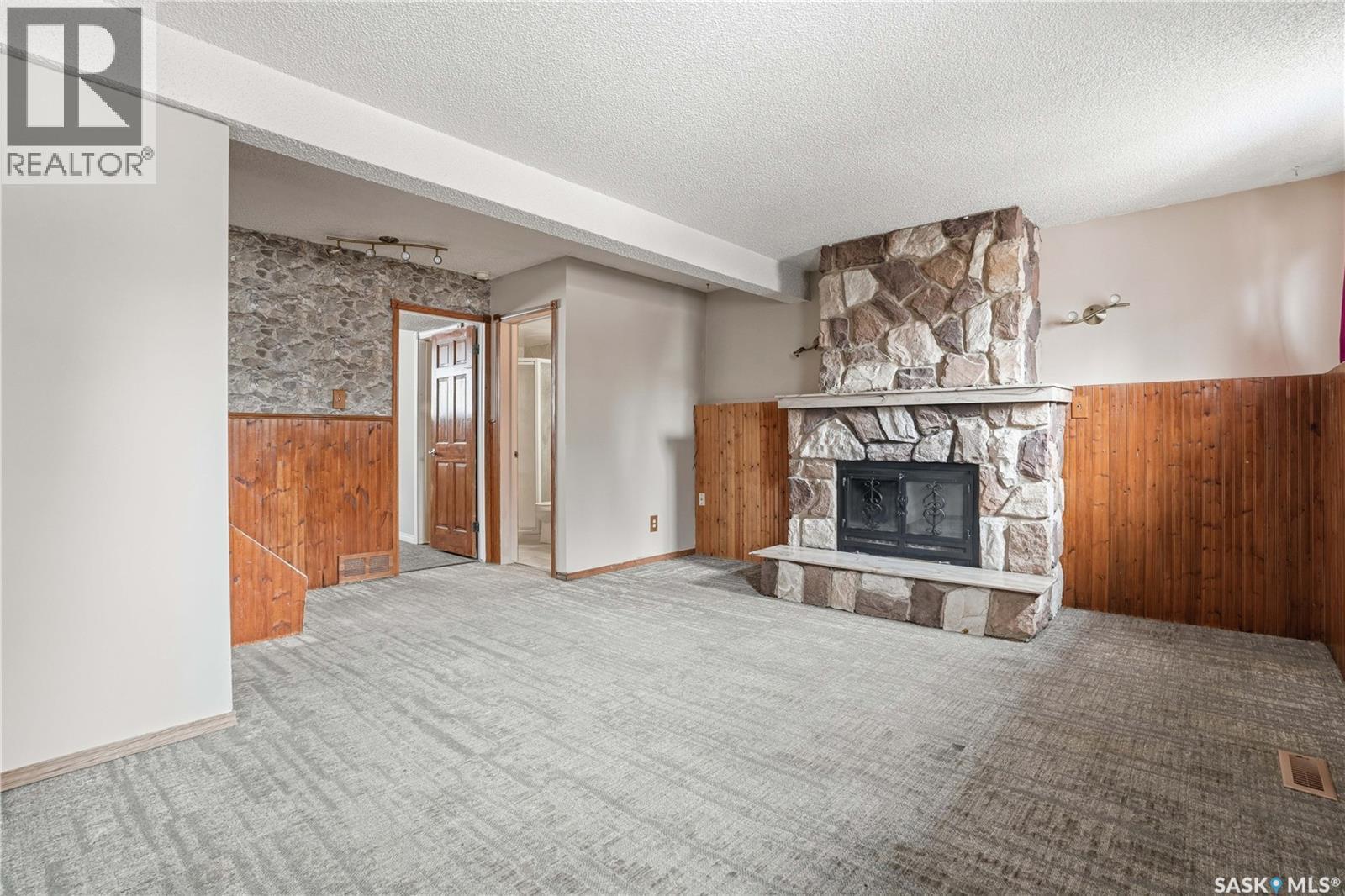 3 Carson Road, Regina, SK - Indoor Photo Showing Living Room With Fireplace