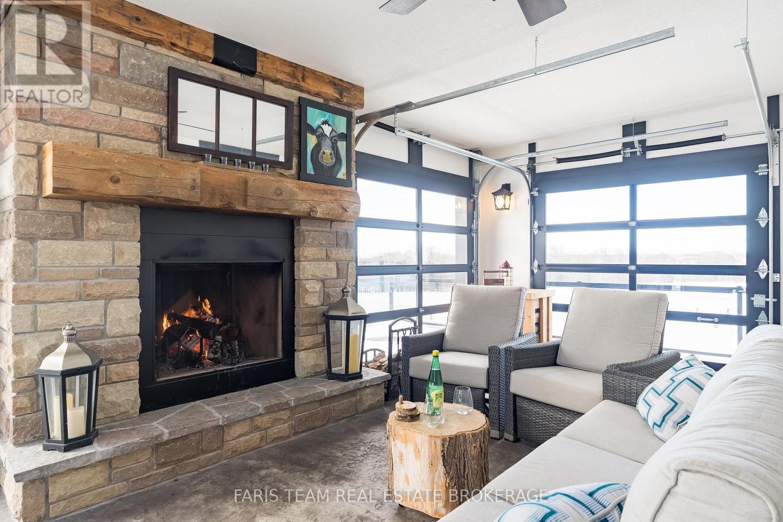 130 Concession 15 W, Tiny, ON - Indoor Photo Showing Living Room With Fireplace