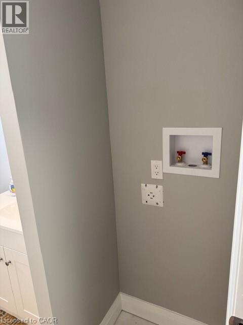 Laundry area with baseboards and washer hookup - 31 Adair Avenue, Hamilton, ON - Indoor Photo Showing Other Room