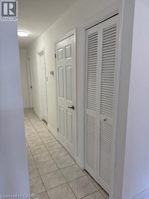 Hallway with light tile patterned floors and baseboards - 31 Adair Avenue, Hamilton, ON - Indoor Photo Showing Other Room