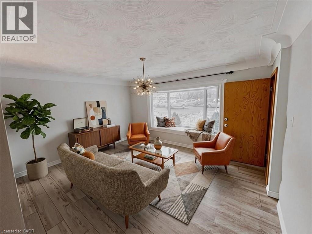 Living area featuring a chandelier and light wood-style flooring. Virtually staged. - 122 Weber Street S, Waterloo, ON - Indoor Photo Showing Other Room