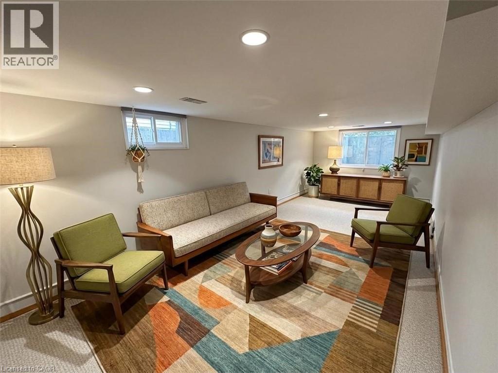 Living room with healthy amount of natural light, recessed lighting, and baseboard heating. Basement. Virtually staged. - 122 Weber Street S, Waterloo, ON - Indoor Photo Showing Other Room