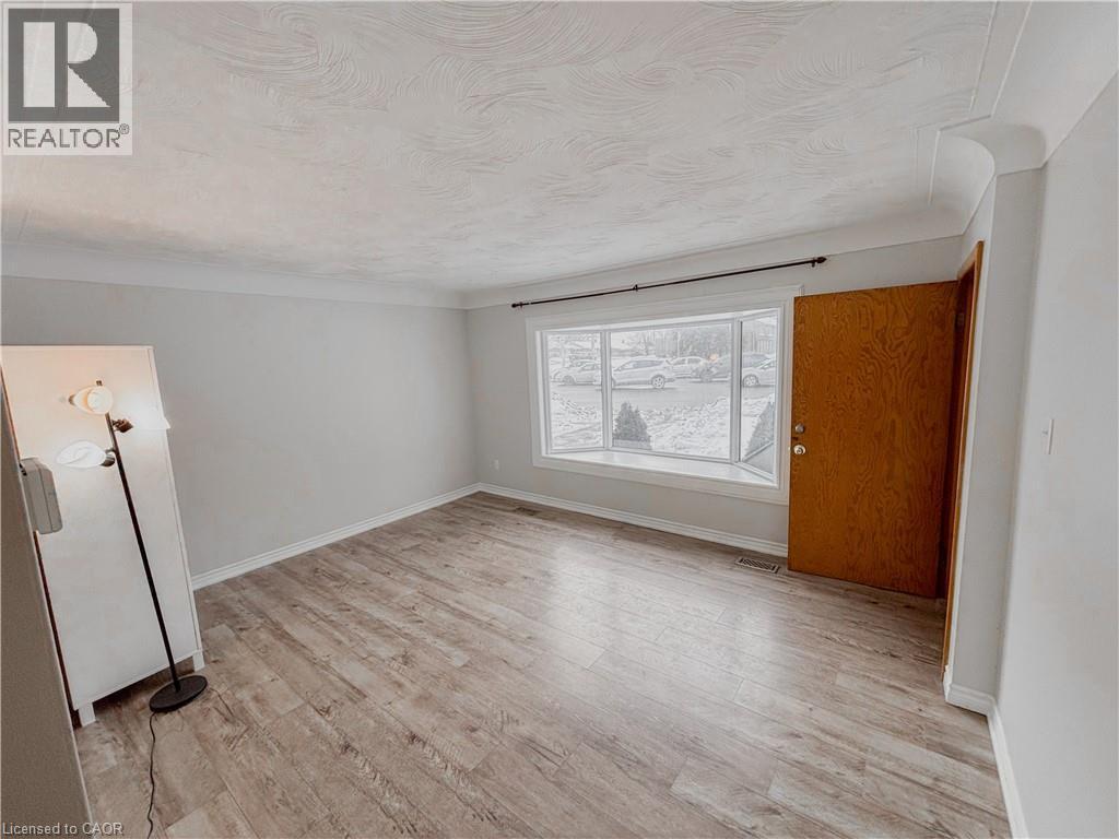 Spare room featuring light wood finished floors and baseboards - 122 Weber Street S, Waterloo, ON - Indoor Photo Showing Other Room