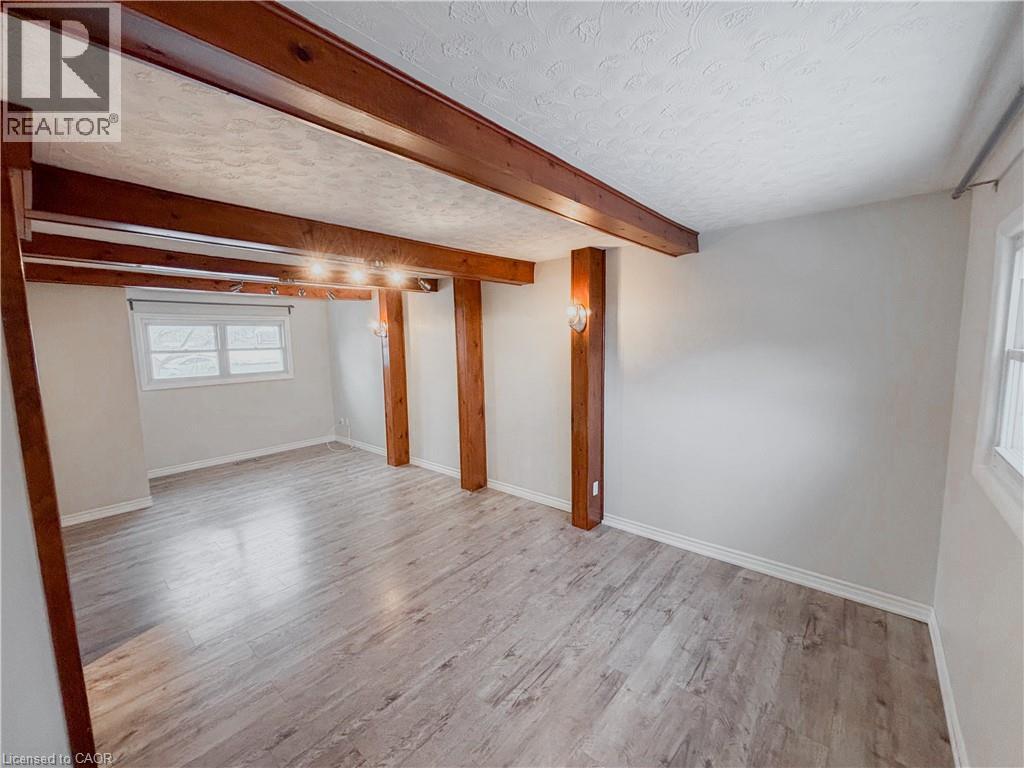 Basement with light wood finished floors and a textured ceiling - 122 Weber Street S, Waterloo, ON - Indoor