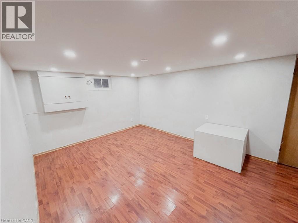 Finished basement with light wood-style floors and recessed lighting - 122 Weber Street S, Waterloo, ON - Indoor