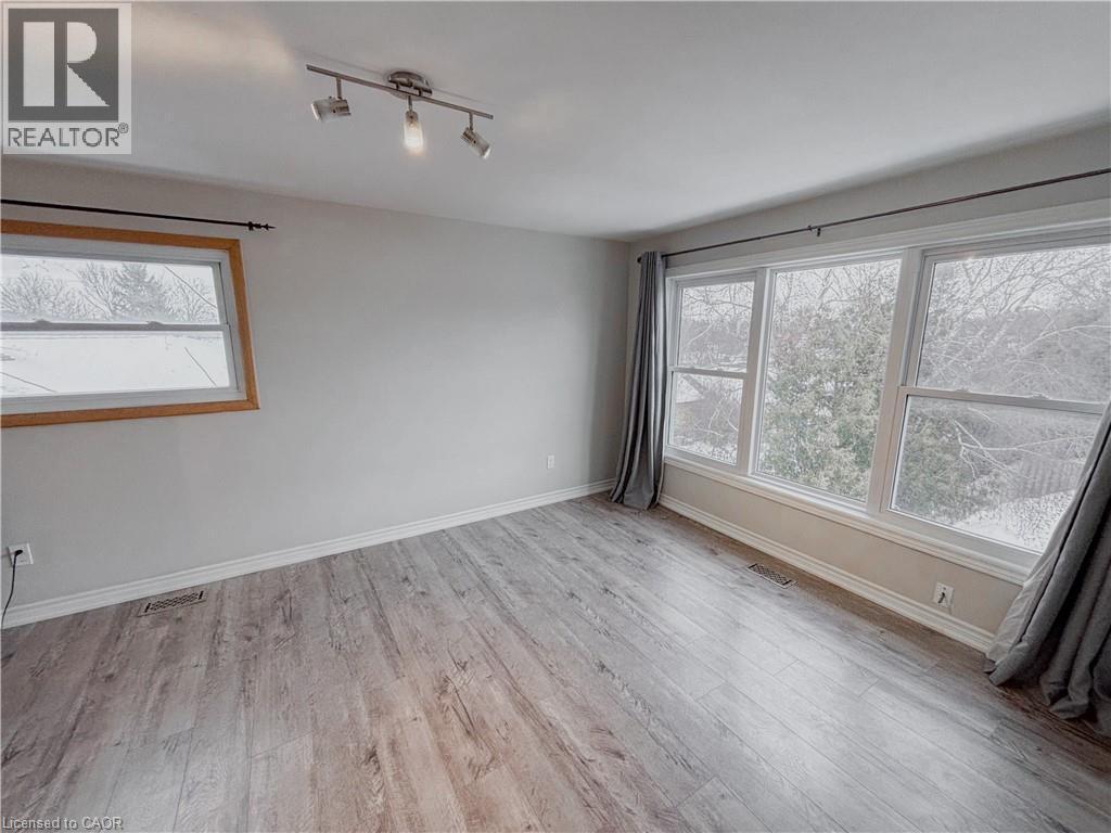 Spare room with light wood-style floors and healthy amount of natural light - 122 Weber Street S, Waterloo, ON - Indoor Photo Showing Other Room