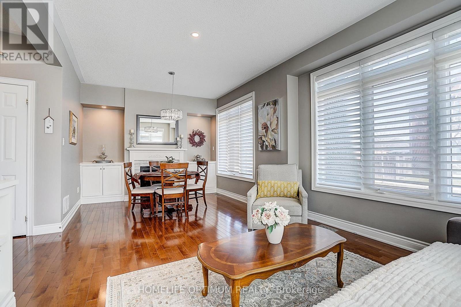Dining room with fireplace and built-in cupboards - 40 Outer Banks Drive N, Markham, ON - Indoor Photo Showing Living Room
