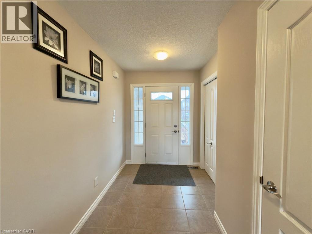 Entryway with a textured ceiling and light tile patterned flooring - 101 Robert Simone Way, Ayr, ON - Indoor Photo Showing Other Room