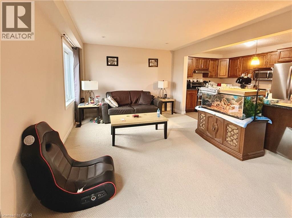 Living area featuring light colored carpet and baseboards - 101 Robert Simone Way, Ayr, ON - Indoor Photo Showing Other Room