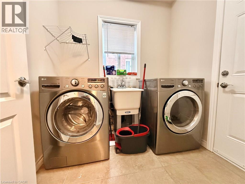 Laundry room with washing machine and clothes dryer - 101 Robert Simone Way, Ayr, ON - Indoor Photo Showing Laundry Room