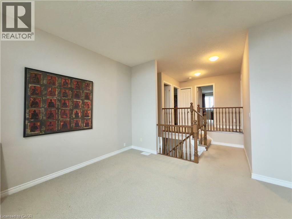 Empty room with baseboards and light colored carpet - 101 Robert Simone Way, Ayr, ON - Indoor Photo Showing Other Room