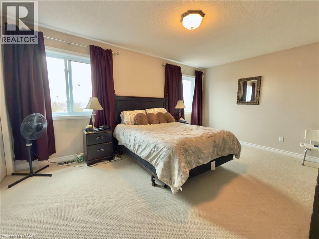 Bedroom with light carpet and a textured ceiling - 101 Robert Simone Way, Ayr, ON - Indoor Photo Showing Bedroom