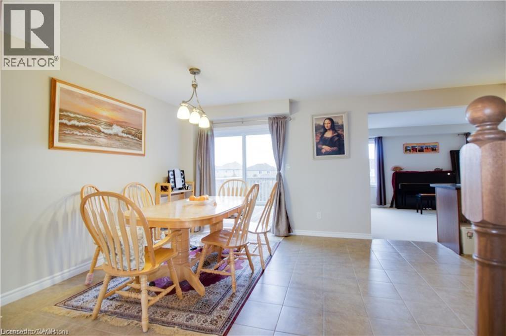 Tiled dining area featuring a notable chandelier - 101 Robert Simone Way, Ayr, ON - Indoor Photo Showing Dining Room