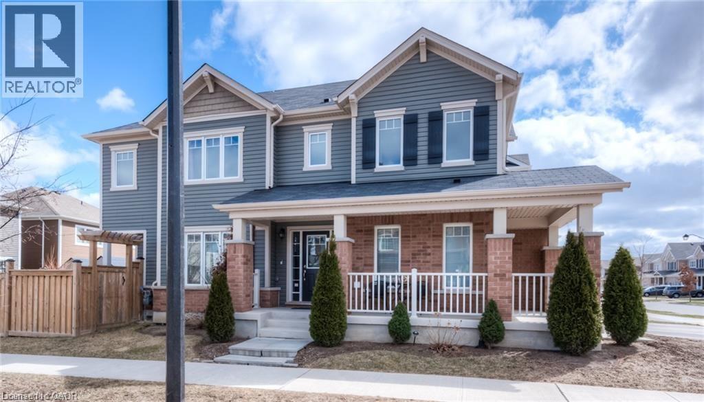 Craftsman-style house featuring a porch and brick siding - 60 Postmaster Drive, Kitchener, ON - Outdoor With Deck Patio Veranda With Facade