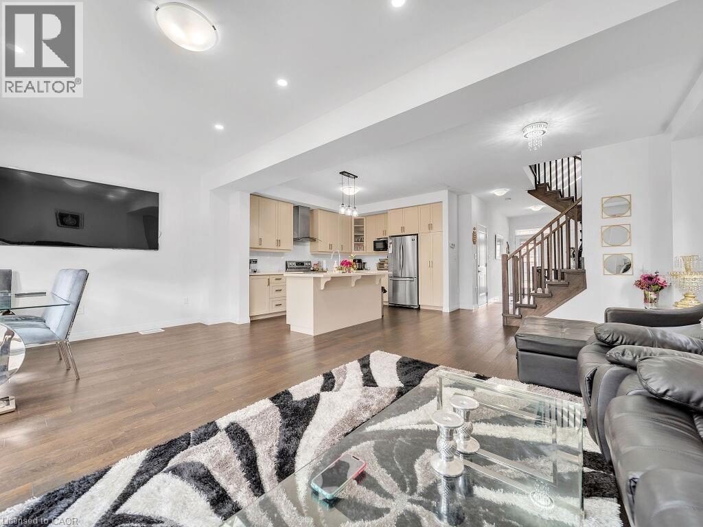 Living room with dark wood finished floors and recessed lighting - 30 Times Square Boulevard, Hamilton, ON - Indoor Photo Showing Living Room