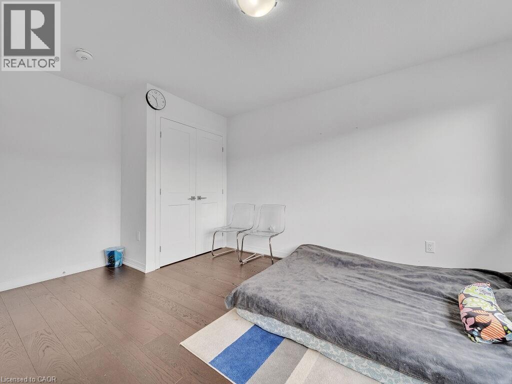 Bedroom with dark wood-style flooring and a closet - 30 Times Square Boulevard, Hamilton, ON - Indoor Photo Showing Bedroom