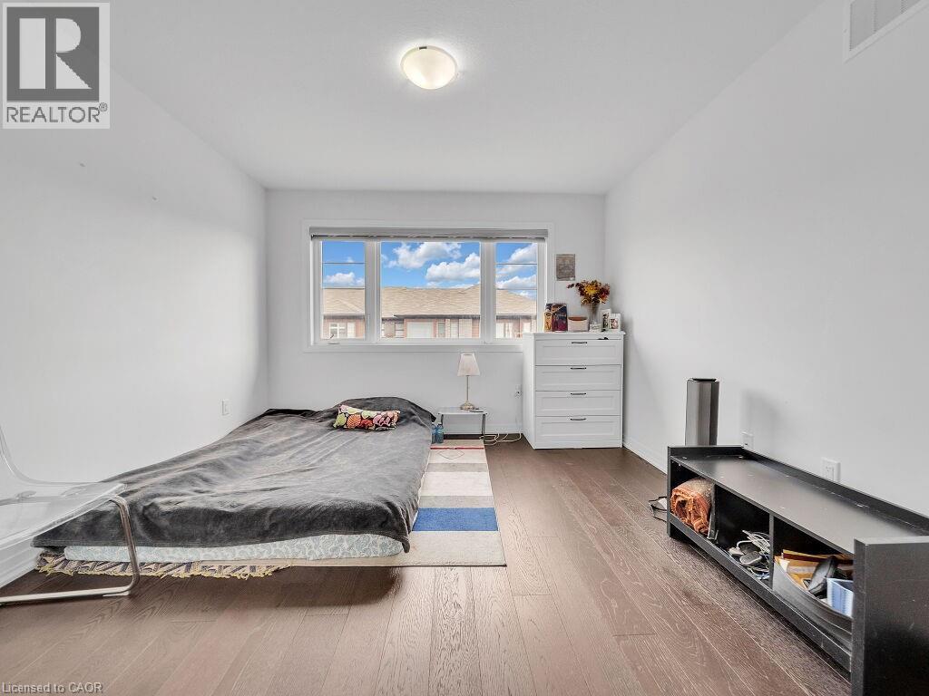 Bedroom with wood-type flooring and baseboards - 30 Times Square Boulevard, Hamilton, ON - Indoor Photo Showing Bedroom