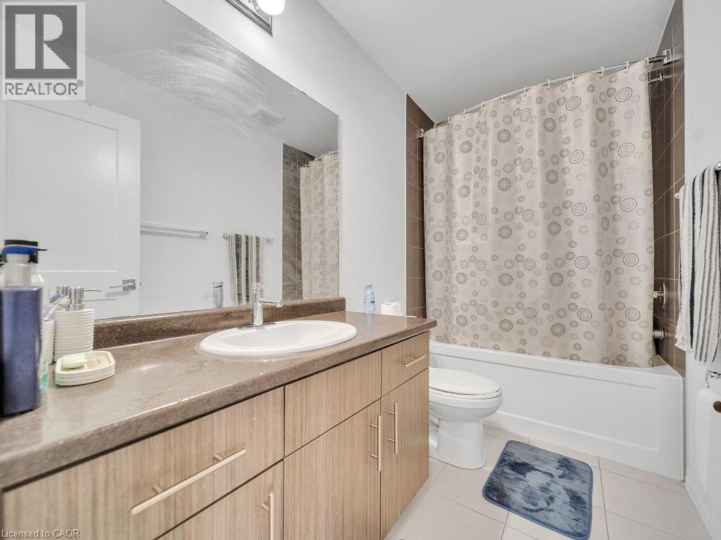 Bathroom featuring shower / bath combo, vanity, and light tile patterned flooring - 30 Times Square Boulevard, Hamilton, ON - Indoor Photo Showing Bathroom