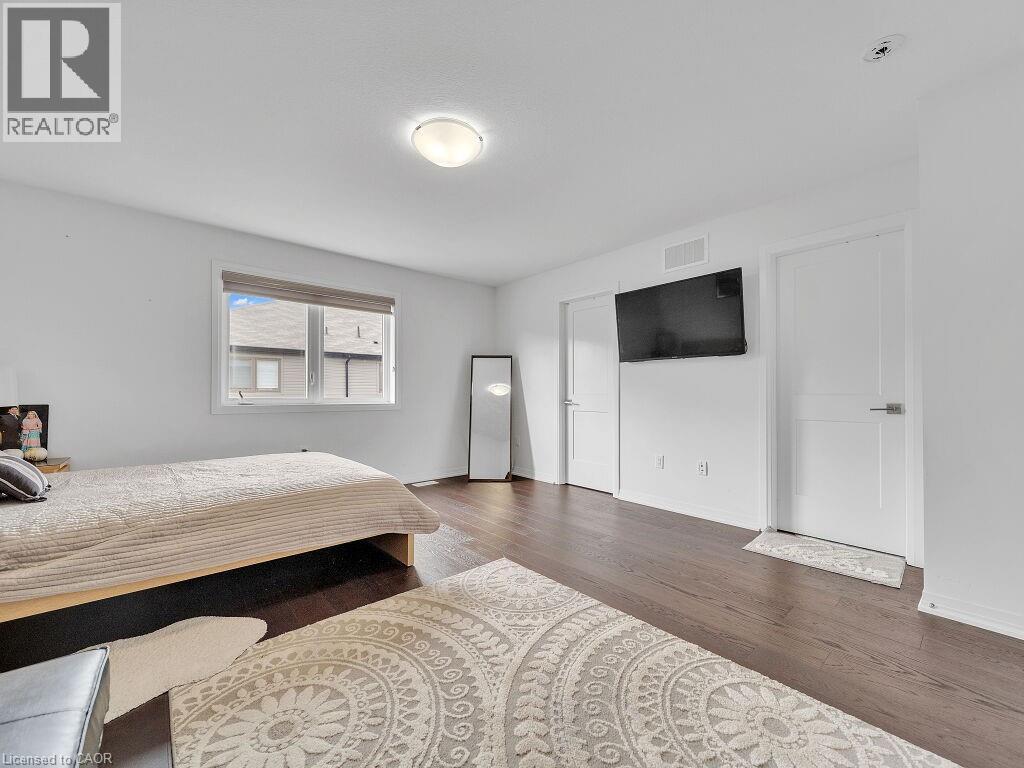 Bedroom with dark wood-type flooring and baseboards - 30 Times Square Boulevard, Hamilton, ON - Indoor Photo Showing Bedroom