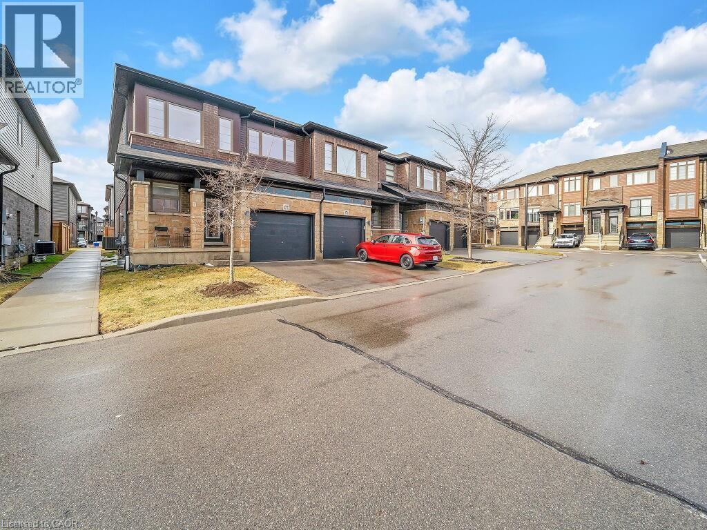 View of asphalt street featuring a residential view and curbs - 30 Times Square Boulevard, Hamilton, ON - Outdoor With Facade