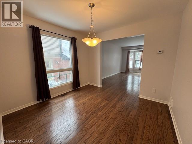 Unfurnished room featuring dark wood-type flooring and baseboards - 536 Thorndale Drive, Waterloo, ON - Indoor Photo Showing Other Room