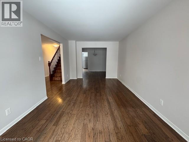 Empty room with dark wood-type flooring and a chandelier - 536 Thorndale Drive, Waterloo, ON - Indoor Photo Showing Other Room