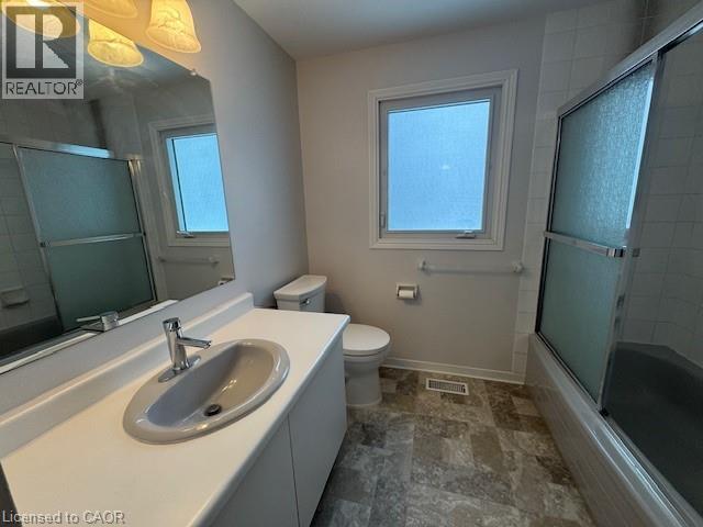 Bathroom featuring vanity, shower / bath combination with glass door, and stone finish flooring - 536 Thorndale Drive, Waterloo, ON - Indoor Photo Showing Bathroom