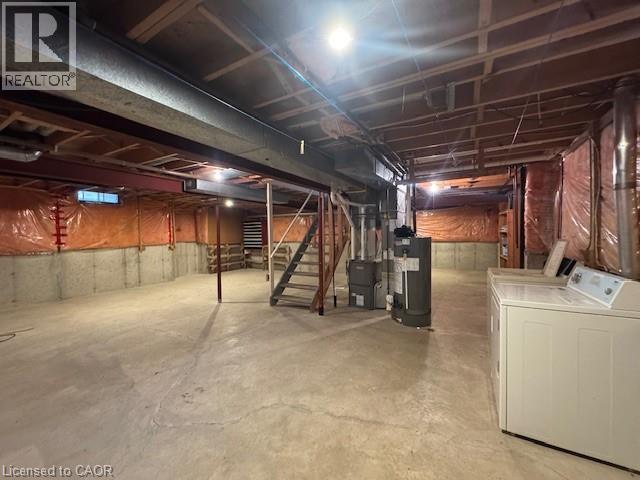 Unfinished basement featuring water heater and washing machine and dryer - 536 Thorndale Drive, Waterloo, ON - Indoor Photo Showing Laundry Room