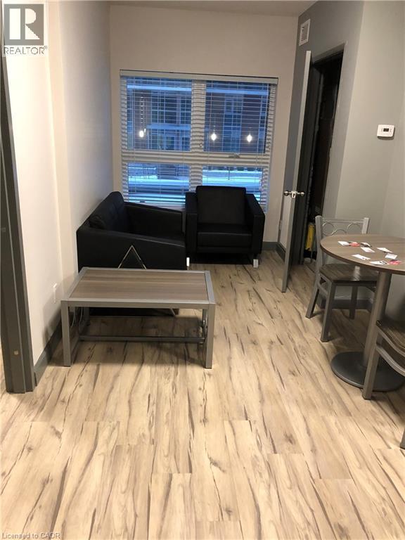Living area featuring light wood-style flooring - 258 Sunview Street Unit# 225, Waterloo, ON - Indoor Photo Showing Other Room