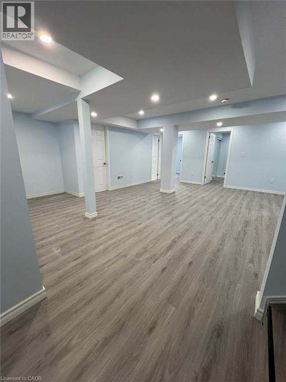 Finished below grade area with dark wood-type flooring and recessed lighting - 167 Histand Trail Unit# Lower, Kitchener, ON - Indoor