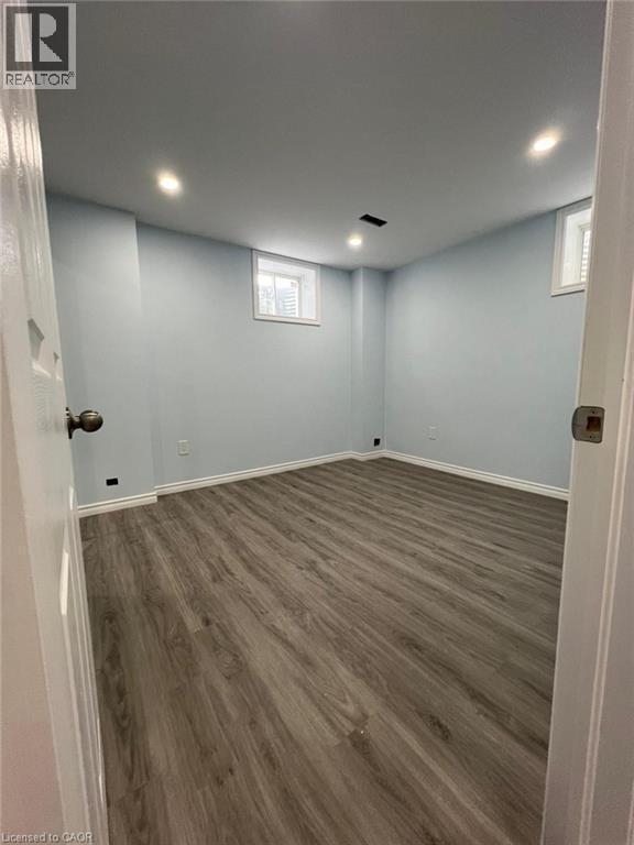 Basement with dark wood-style floors and recessed lighting - 167 Histand Trail Unit# Lower, Kitchener, ON - Indoor