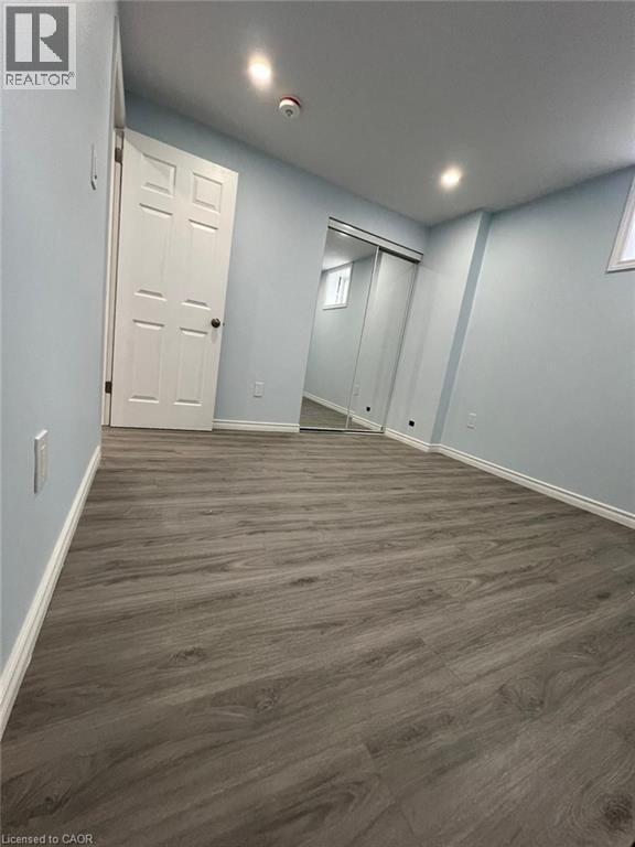 Below grade area with dark wood-style flooring and recessed lighting - 167 Histand Trail Unit# Lower, Kitchener, ON - Indoor