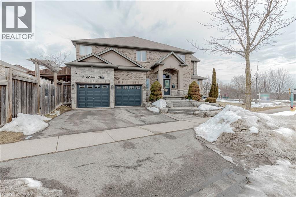 French provincial home featuring brick siding, asphalt driveway, and a garage - 2 Doon Creek Street, Kitchener, ON - Outdoor With Facade