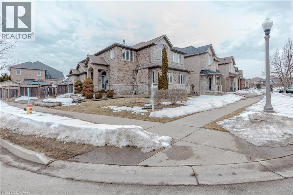 View of front facade featuring a residential view, stone siding, and brick siding - 2 Doon Creek Street, Kitchener, ON - Outdoor With Facade