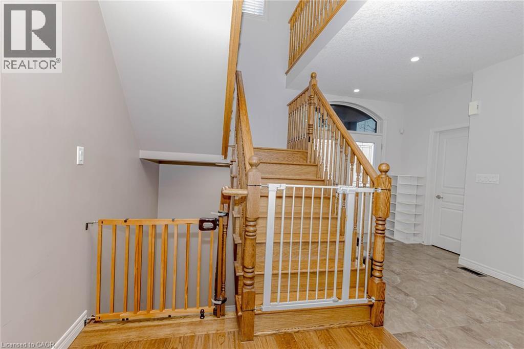 Stairway with wood finished floors and recessed lighting - 2 Doon Creek Street, Kitchener, ON - Indoor Photo Showing Other Room