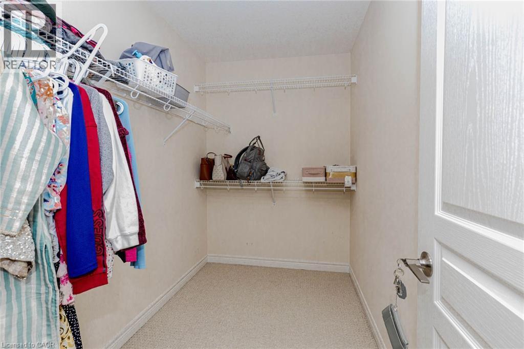 Walk in closet with light carpet - 2 Doon Creek Street, Kitchener, ON - Indoor With Storage